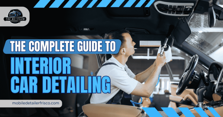 Professional detailer using an air compressor to clean the interior roof and sun visor of a car as part of an interior car detailing service.